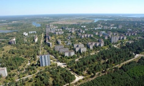 The deserted city of Pripyat. Pripyat was home to the workers of Chernobyl and their families (approximately 50 000 people). It's now a nuclear ghost town. The Chernobyl nuclear power station is in the background.